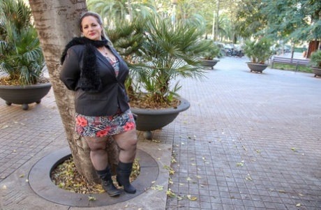 Hot mature BBW Sophia Lola showing her clothed big breasts outdoors