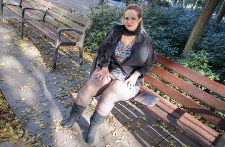 Hot mature BBW Sophia Lola showing her clothed big breasts outdoors