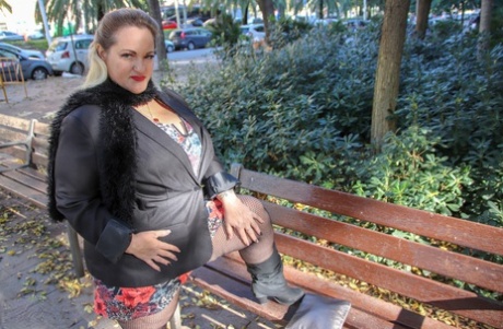 Hot mature BBW Sophia Lola showing her clothed big breasts outdoors