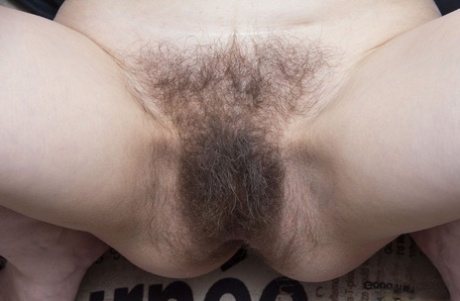 Mature American Trixie gets rid of her clothes and shows her furry crotch