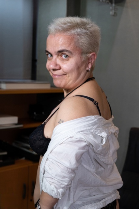 Short-haired amateur midget Sara One strips to her lingerie at the office
