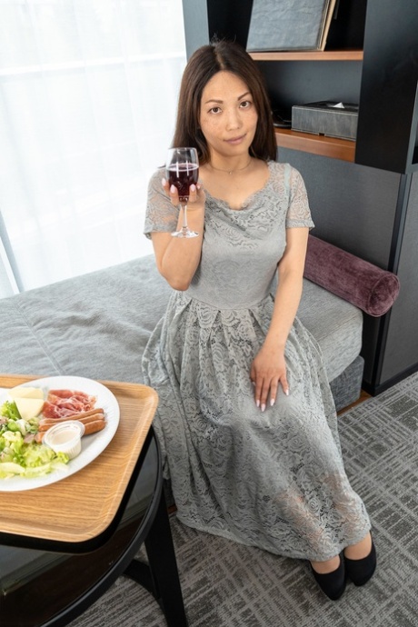 Cute MILF Midori Minami strips naked and poses enticingly in a hotel room
