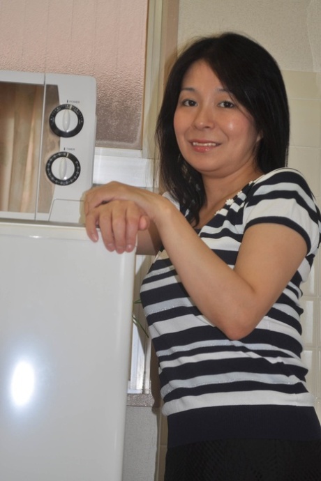 Petite Japanese granny Akiko Oda strips and shows her bushy wet beaver