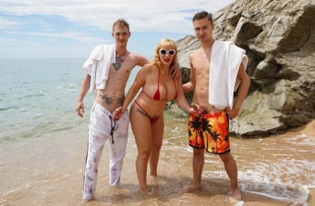 Skilled granny Victoria Cruz sucking & fucking two dicks in a beach threesome