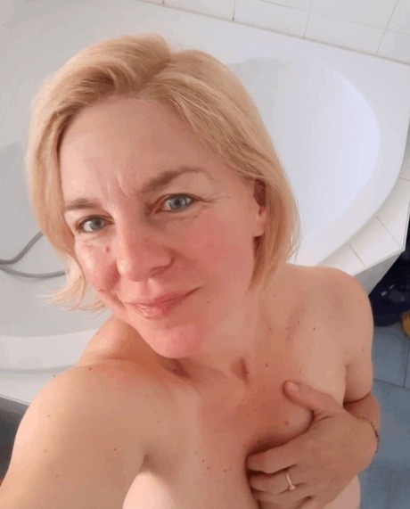 Busty amateur teases with her big tits while taking nude selfies