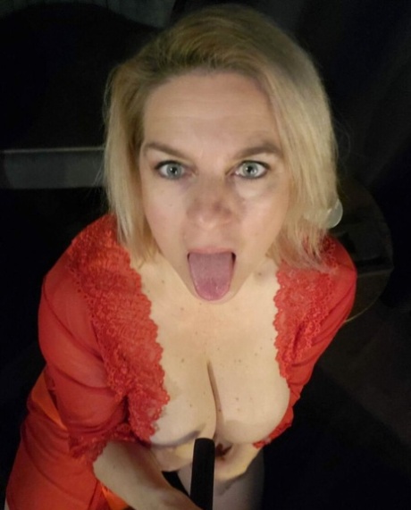 Glamorous cougar teases with her sexy cleavage while posing in her lingerie