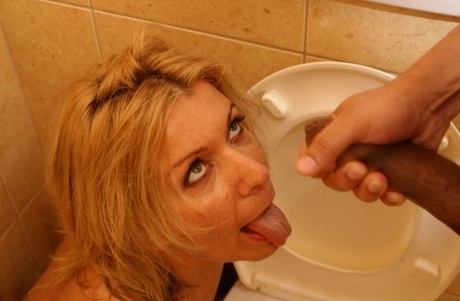 Blonde mom Noura pees and takes a stiff boner in her twat in the toilet