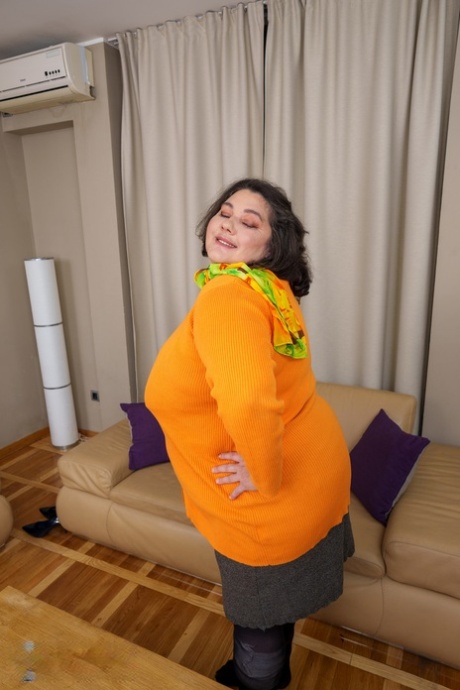 Mature fatty Edina flaunts her big booty while teasing in stockings
