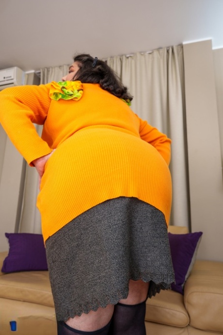 Mature fatty Edina flaunts her big booty while teasing in stockings