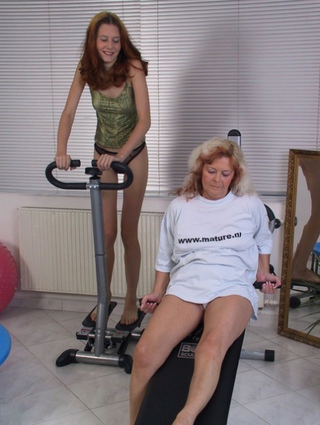 Horny granny Amelda and skinny teen Selena undress and play with a dildo